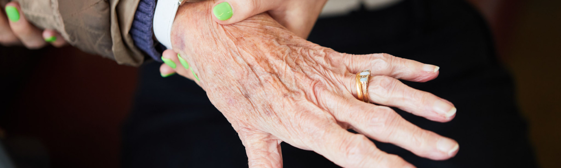 A photo showing a patient having their pulse checked