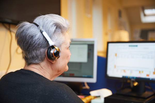 A photo showing a call handler using a computer